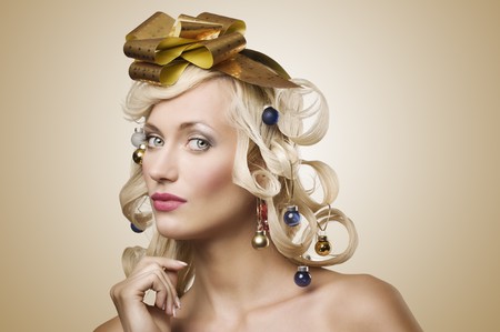 fashion shot of a blond girl with curly hair stylish like a christmas tree with little noel decorationの写真素材
