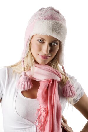 close up portrait of a young beautiful model in white winter dress with a nice hat and pink scarf 
の写真素材