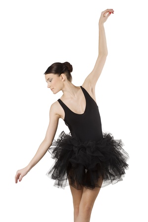 graceful ballerina in black tutu taking a classical dancing pose looking downの写真素材