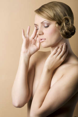 graceful blond woman with naked shoulder and old fashion hair style on sepia background の写真素材
