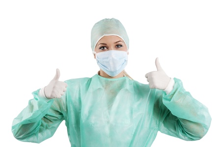 positive young beauty nurse in green operation dress with surgery cap and maskの写真素材