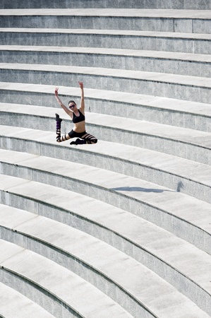 young cute dancer woman jumping outside in a modern arena theater
の写真素材