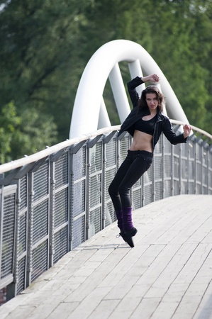 beautiful sexy woman on black trying to take a ballet pose on pointe outdoorの写真素材