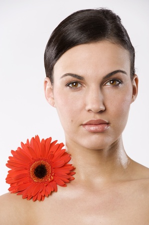 fresh portrait of a young brunette woman wiith color flower without skin retouchの写真素材