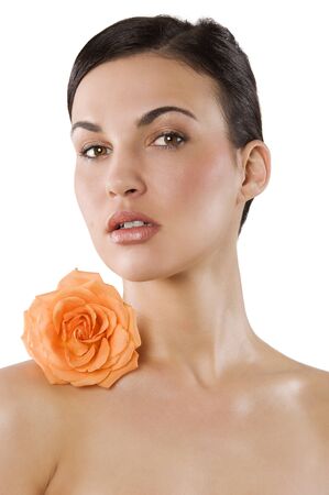 fresh portrait of a young brunette woman wiith color flower near the her faceの写真素材