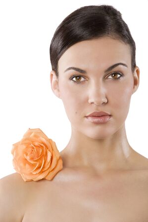 fresh portrait of a young brunette woman wiith color flower near the her faceの写真素材