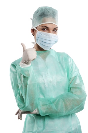 positive doctor woman in surgery dress making a sign with handの写真素材
