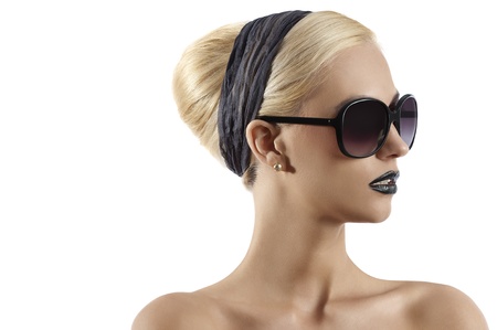 fashion portrait of young blond woman with hair style black lips and wearing sunglasses against white backgroundの写真素材