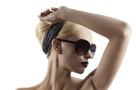fashion portrait of young blond woman with hair style black lips and wearing sunglasses posing against white backgroundの写真素材