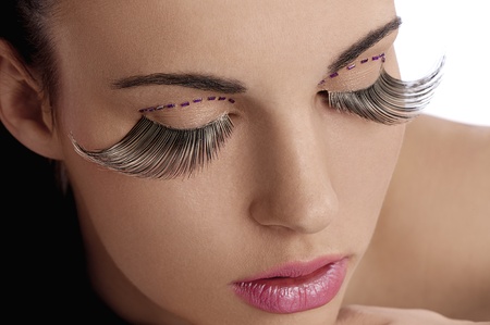 close shot of pretty and sensual brunette  and creative make up with long eyelashesの写真素材