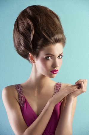 fashion shot of a beautiful brunette with a couture hair style wearing a pink evening dressの写真素材
