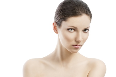 Beauty style portrait of young woman with healthy skin and wet hair . close up on face, she is in front of the camera, looks in to the lens and her face is turned of three-quartersの写真素材