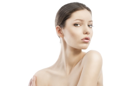 Beauty style portrait of young woman with healthy skin and wet hair . close up on face. Her face is turned of three- quarters, she looks in to the lens and has the left shoulder more raised than the right.の写真素材
