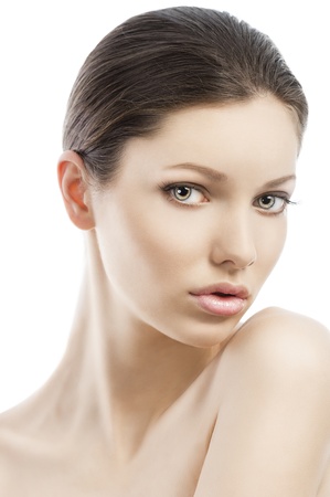 Beauty style portrait of young woman with healthy skin and wet hair . close up on face, her face is turned of three quarters and is near the left shoulder. she looks in to the lensの写真素材