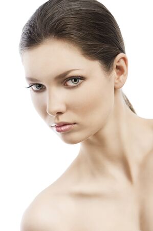 Beauty style portrait of young woman with healthy skin and wet hair . she is skewed to the and looks in to the lens, her face is turned of three-quartersの写真素材