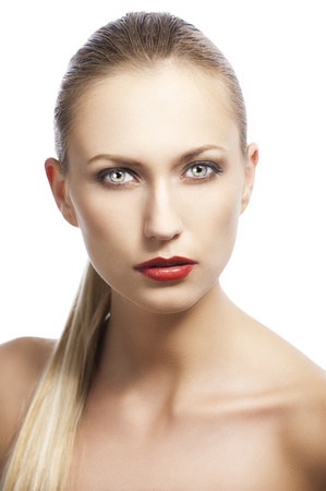 blond pretty woman in a beauty portrait with wet hair and a straight tail over shoulder. She looks in to the lens and she has the tail over the right shoulder.の写真素材