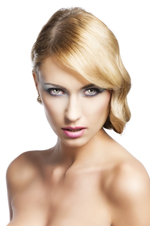 blond beautiful woman with strong make up and an old fashion hair stylish in beauty portrait close up. She looks in to the lens with actractive expression and her mouth is slightly openの写真素材