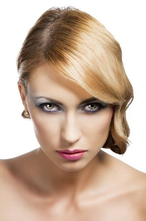 blond beautiful woman with strong make up and an old fashion hair stylish in beauty portrait close up, she is in front of the camera, looks in to the lens with actractive expressionの写真素材
