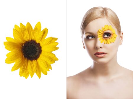 beauty young girl with a floral makeup. She is turned of three quarters and looks in to the lens with attractive expressionの写真素材