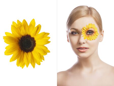 beauty young girl with a floral makeup. She is turned of three quarters and looks in to the lens with attractive expressionの写真素材