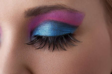 close up on the eye of a beauty model with colorful and creative make up 