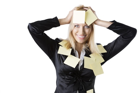  pretty business woman with black jacket and some post-it on her body, she looks in to the lens and smiles and her both hads are on the headの写真素材