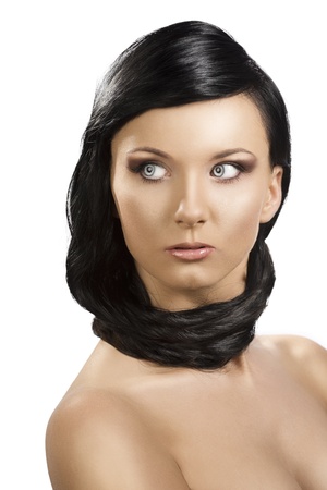 pretty brunete girl with long hair around the neck, she is in front of the camera and looks at rightの写真素材