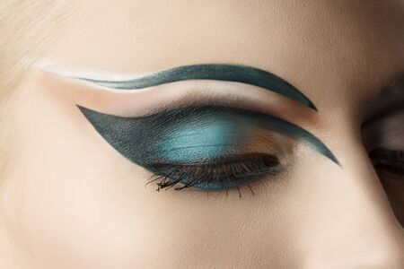 girl's eye closeup with creative green makeup, it's closedの写真素材