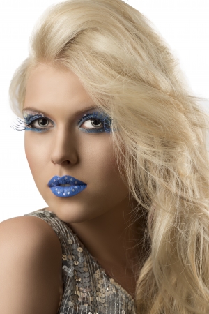 sexy blonde girl with euro flag make-up and glitter dress, she is turned of three quarters and looks in to the lensの写真素材