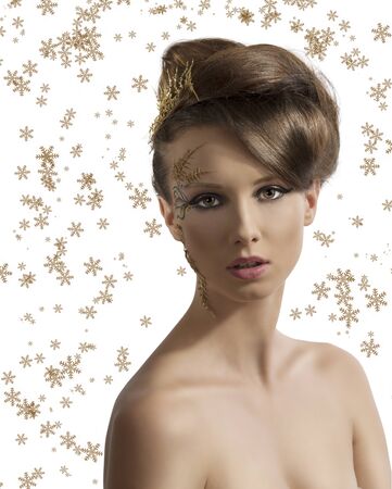 beautiful woman with christmas make-up and hair decoration, she is in front of the camera and looks in to the lensの写真素材