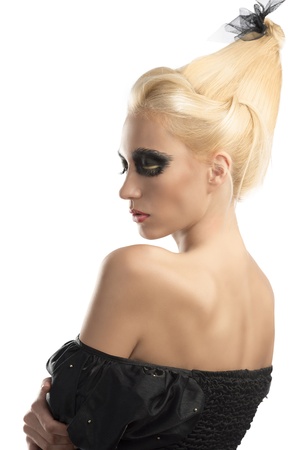 pretty blonde girl with creative dark make-up and upward hairstyle, she is turned back and shows her nacked left shoulderの写真素材