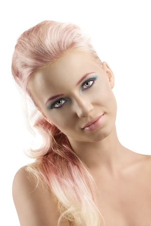pretty girl with blonde long hair and coloured make-up, her head is folded at right and she looks in to the lensの写真素材