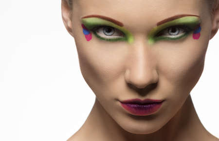 blonde girl with coloured make-up, looks in to the lens with endearing expressionの写真素材