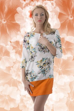 pretty blonde girl with flower in the hair clothing dress with floral patternの写真素材