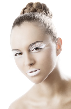 beauty young girl with a floral makeup. She is turned of three quarters and looks in to the lens with attractive expressionの写真素材