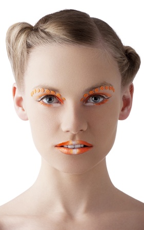 beauty young girl with a floral makeup. She is turned of three quarters and looks in to the lens with attractive expressionの写真素材