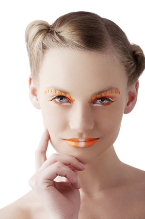 beauty young girl with a floral makeup. She is turned of three quarters and looks in to the lens with attractive expressionの写真素材