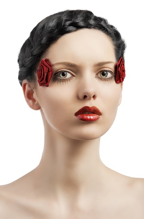 beauty young girl with a floral makeup. She is turned of three quarters and looks in to the lens with attractive expressionの写真素材