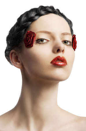 beauty young girl with a floral makeup. She is turned of three quarters and looks in to the lens with attractive expressionの写真素材