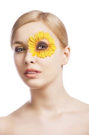beauty young girl with a floral makeup. She looks in to the lens and her mouth is sligthly open.の写真素材
