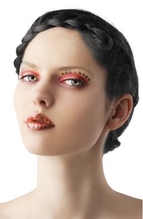 beauty young girl with a floral makeup. She is turned of three quarters and looks in to the lens with attractive expressionの写真素材