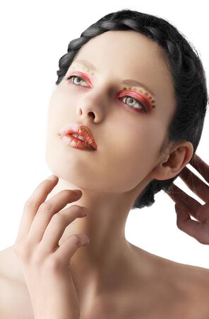 beauty young girl with a floral makeup. She is turned of three quarters and looks in to the lens with attractive expressionの写真素材