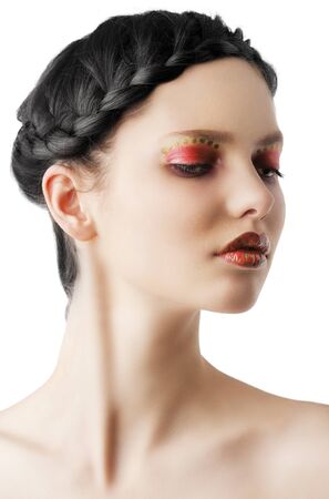beauty young girl with a floral makeup. She is turned of three quarters and looks in to the lens with attractive expressionの写真素材