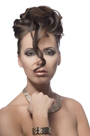 pretty brunette girl with elegant curly hairstyle and make-up, bright necklace and bracelet on white backgroundの写真素材