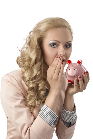 beutiful blonde woman with curly hair-style wearing business suit and taking piggybank in the hand. She speaking with thatの写真素材