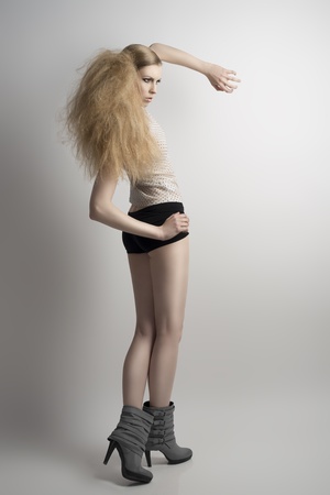 pretty young girl in fashion pose and creative hair-styleの写真素材