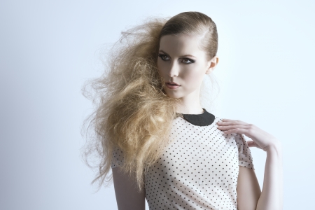 beauty blonde woman with dark make-up and creative punk hair-style posing in fashion portrait  の写真素材