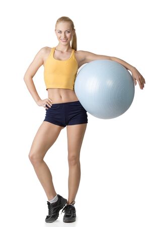 beautiful blond girl in fitness dress keeping a big gym ball isolated on white. NATURAL SKINの写真素材