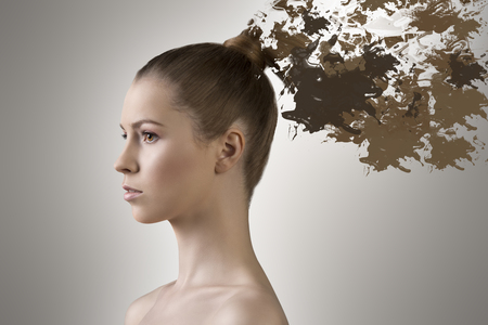 beautiful girl with nude shoulders and long smooth blonde hair melting in paintの写真素材
