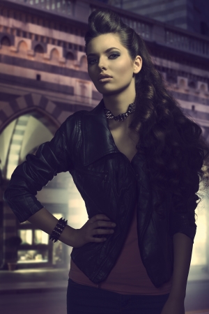fashion portrait of cute young girl with dark rock style, leather jacket and long wavy hair  の写真素材